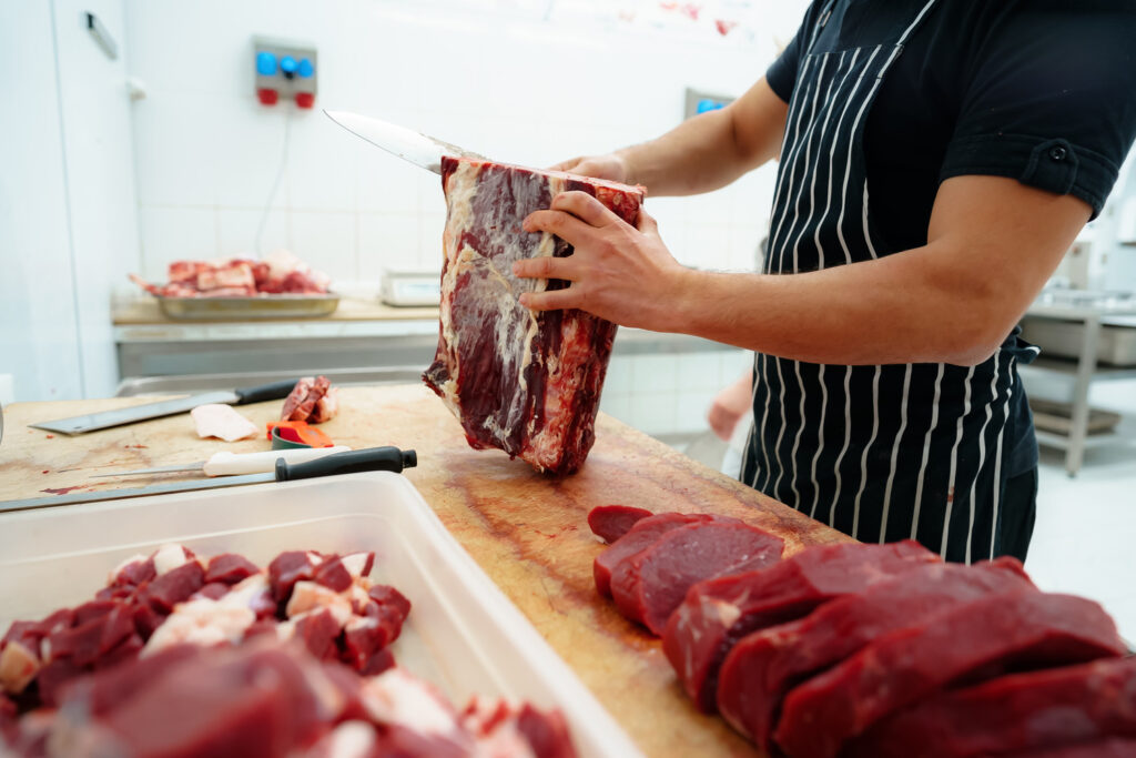 Close Up Of Male Hands Cutting Raw Meat On Wooden 2023 11 27 04 48 59 Utc 1