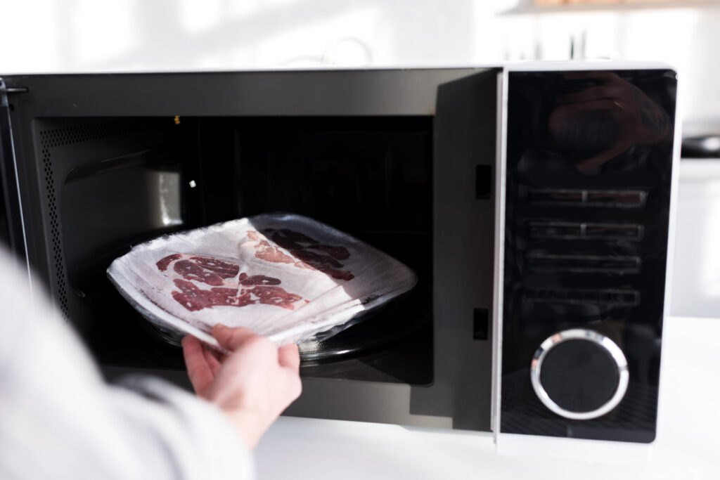 Cropped View Of Woman Putting Meat Into Microwave 2024 11 18 12 38 32 Utc 1