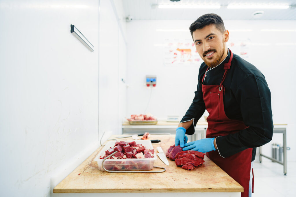 Butcher Cutting Slices Of Raw Meat On Wooden Board 2023 11 27 05 00 07 Utc 1